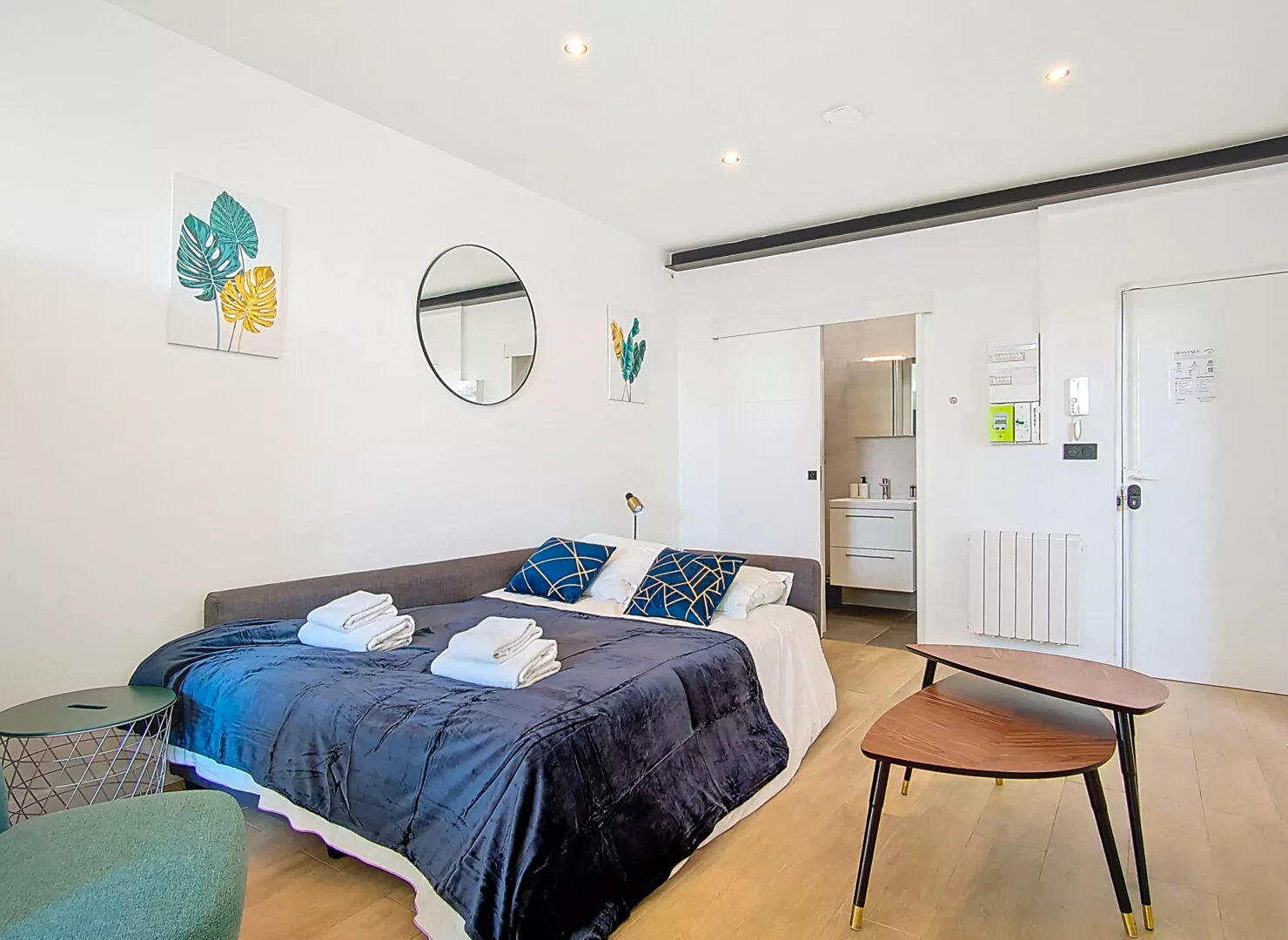 canape lit location appartement court sejour argenteuil Chambre moderne avec salle de bain et décoration colorée.